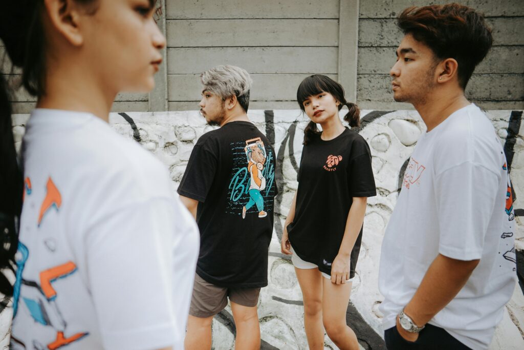 pexels-photo-5192297-5192297 Group of cool diverse millennials people in casual clothes walking near painted graffiti wall in city street in daylight in summer