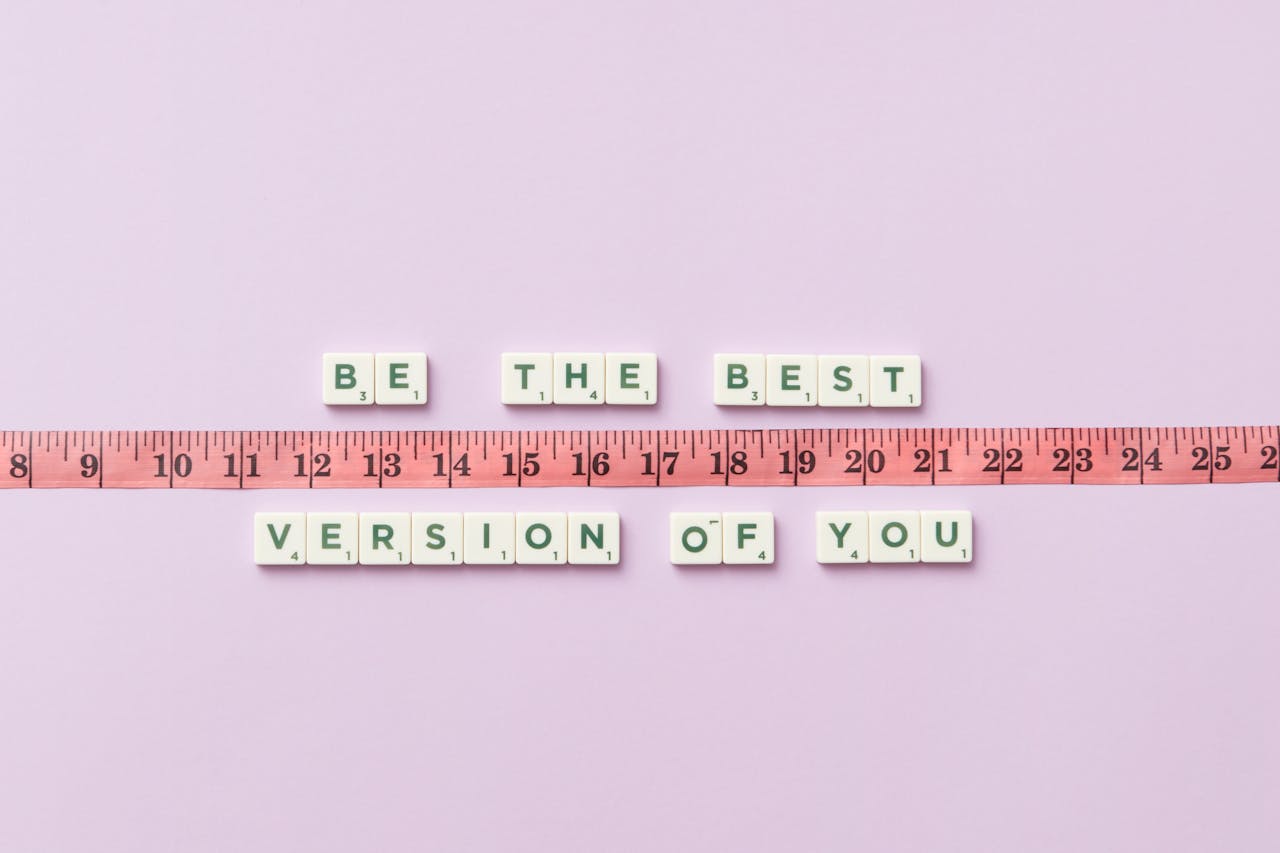 Motivational phrase 'Be the Best Version of You' with a measuring tape on purple background.